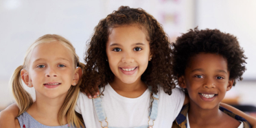 Three young children smiling | Wired Orthodontics blog