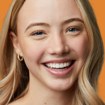 woman smiling wearing a clear retainer replacement in austin tx