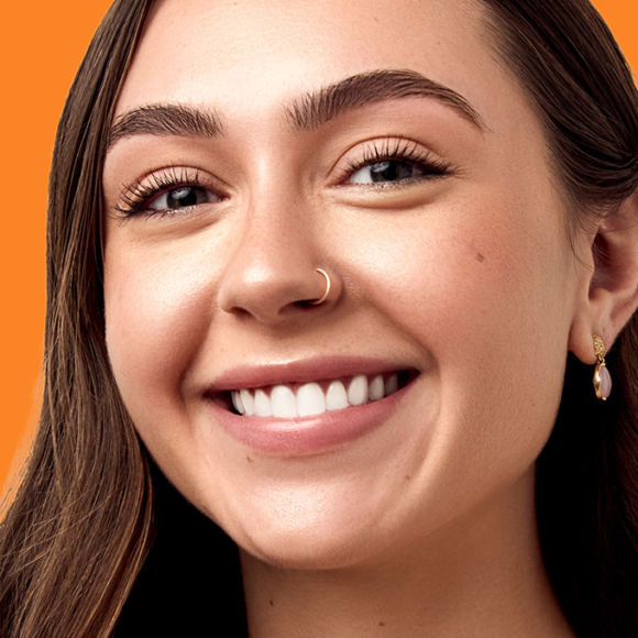 woman smiling wearing orthodontic retainer 101